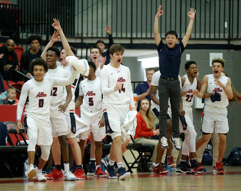 Allen players celebrate a teammates three point shot during the first half of a boys Class...