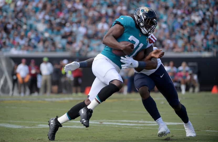 Jacksonville Jaguars running back Jamaal Charles (31) is tackled by Houston Texans...