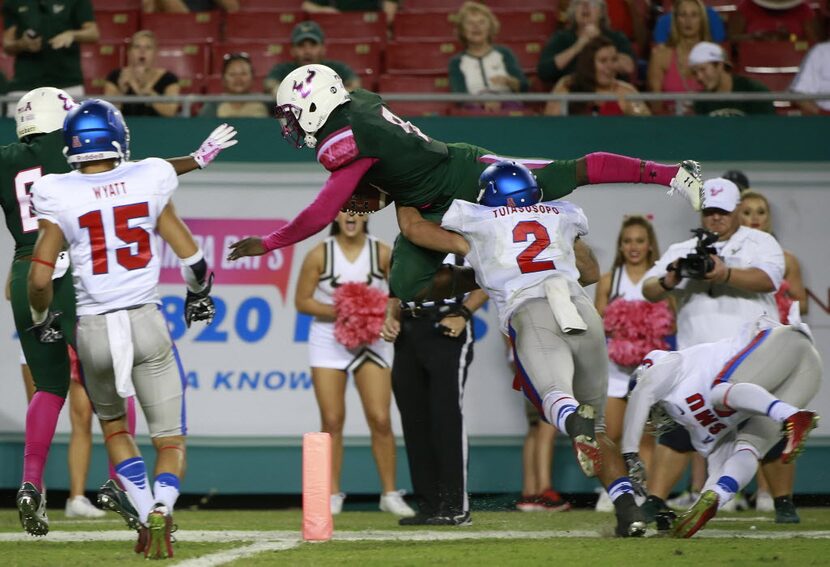 Oct 24, 2015; Tampa, FL, USA; South Florida Bulls quarterback Quinton Flowers (9) jumps into...