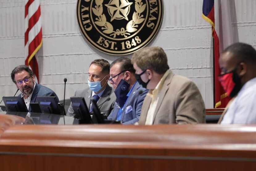 Mayor George Fuller, left, talks during a city council meeting in McKinney, TX, on Aug. 18,...