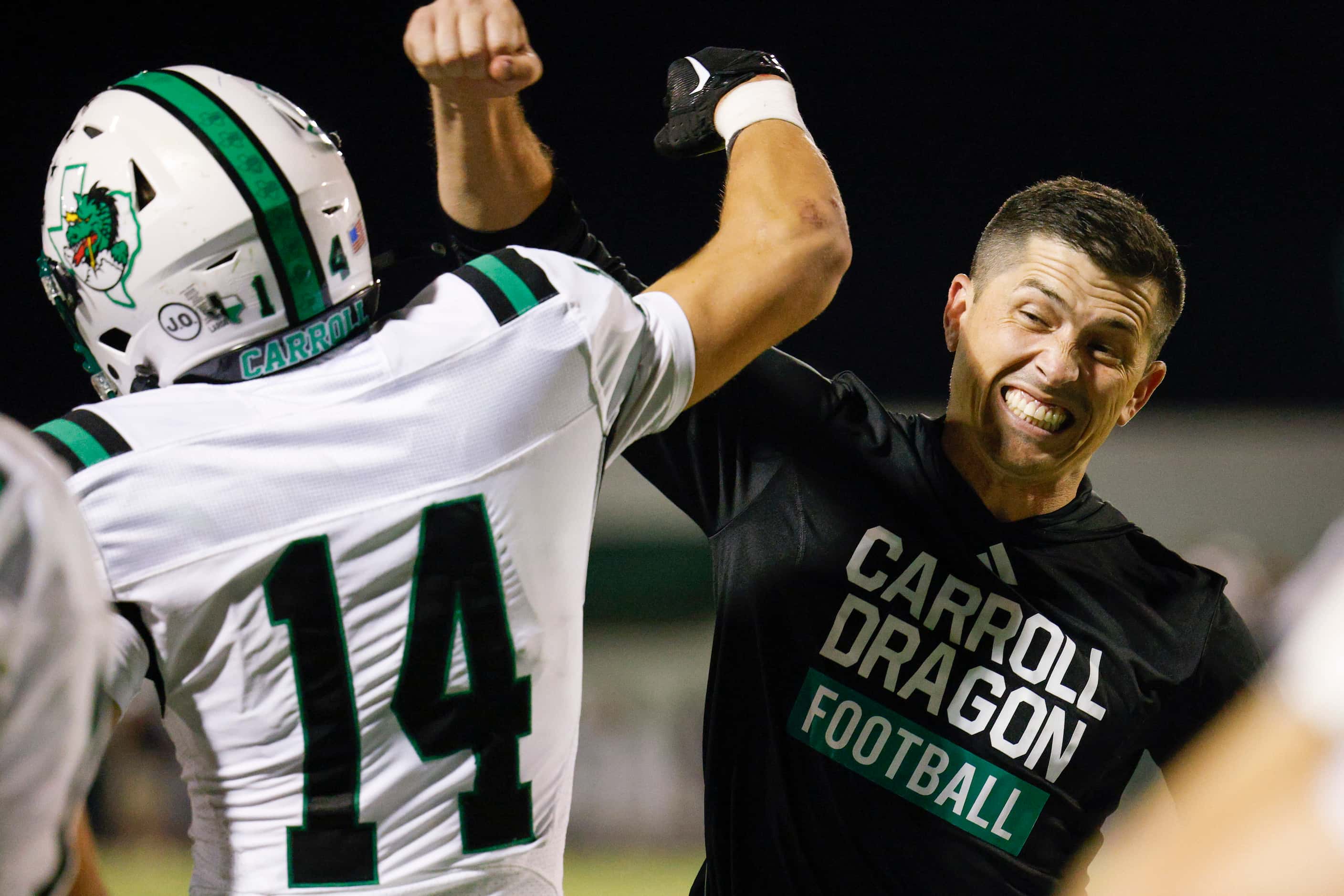 Southlake Carroll head coach Riley Dodge celebrates with wide receiver Clayton Wayland (14)...