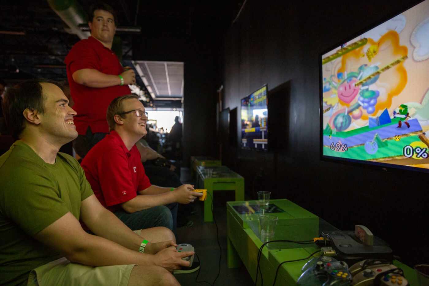 Friends Jon Goodwin (left) and Shaun Hands (middle) play Super Smash Bros. on Nintendo 64 at...