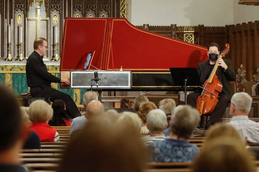 Scott Dettra (left) plays the harpsichord while Eric Smith plays the viola da gamba during...