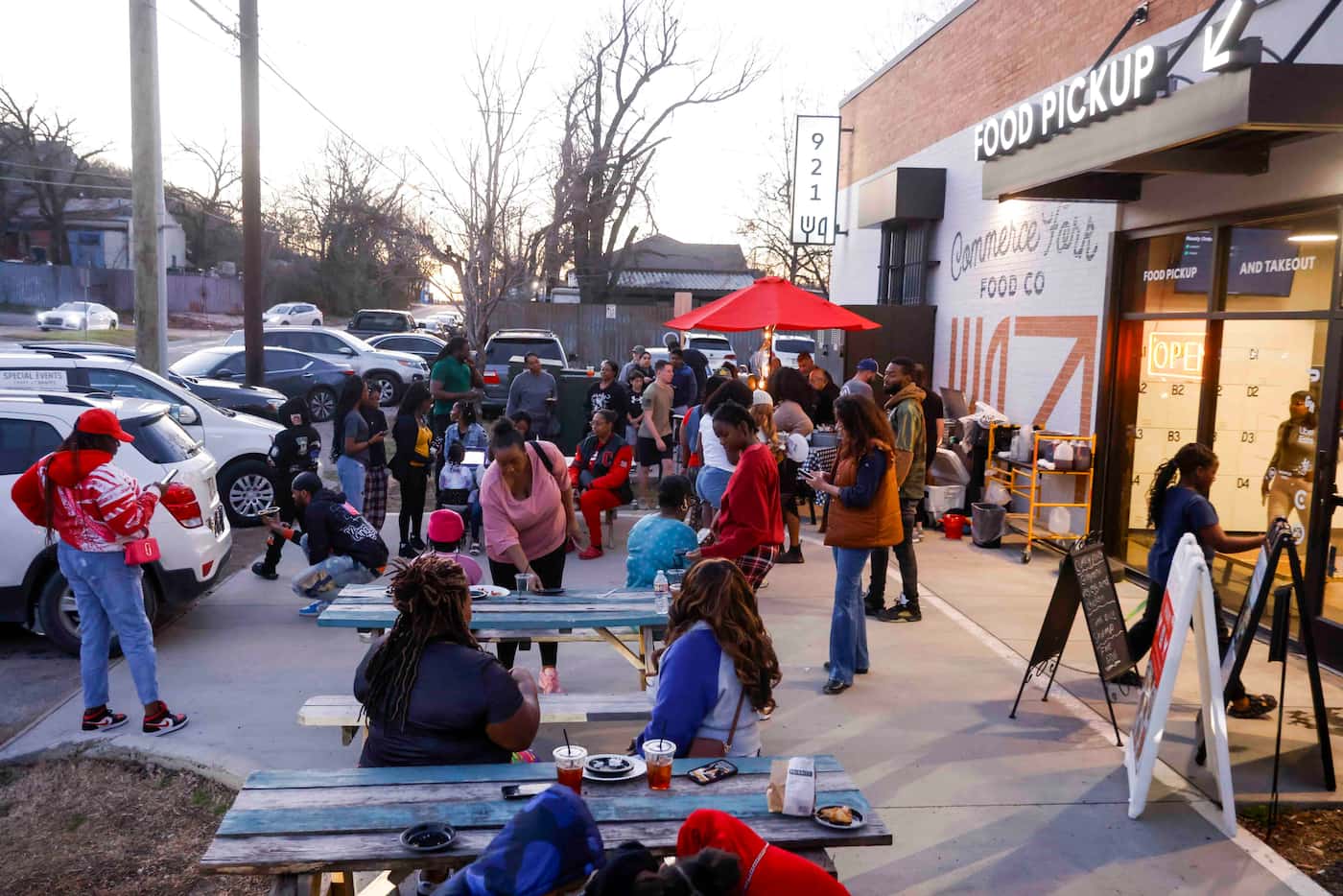 People gather at a pop-up hosted by Seasoned Street Food catering business, Saturday, Feb....