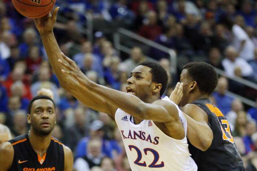 Kansas guard Andrew Wiggins (22) is fouled by Oklahoma State guard Leyton Hammonds, right, ...