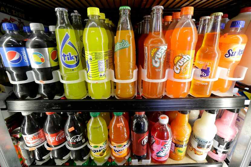 Soft drink and soda bottles displayed in a supermarket refrigerator. (AP Photo/Jeff Chiu)