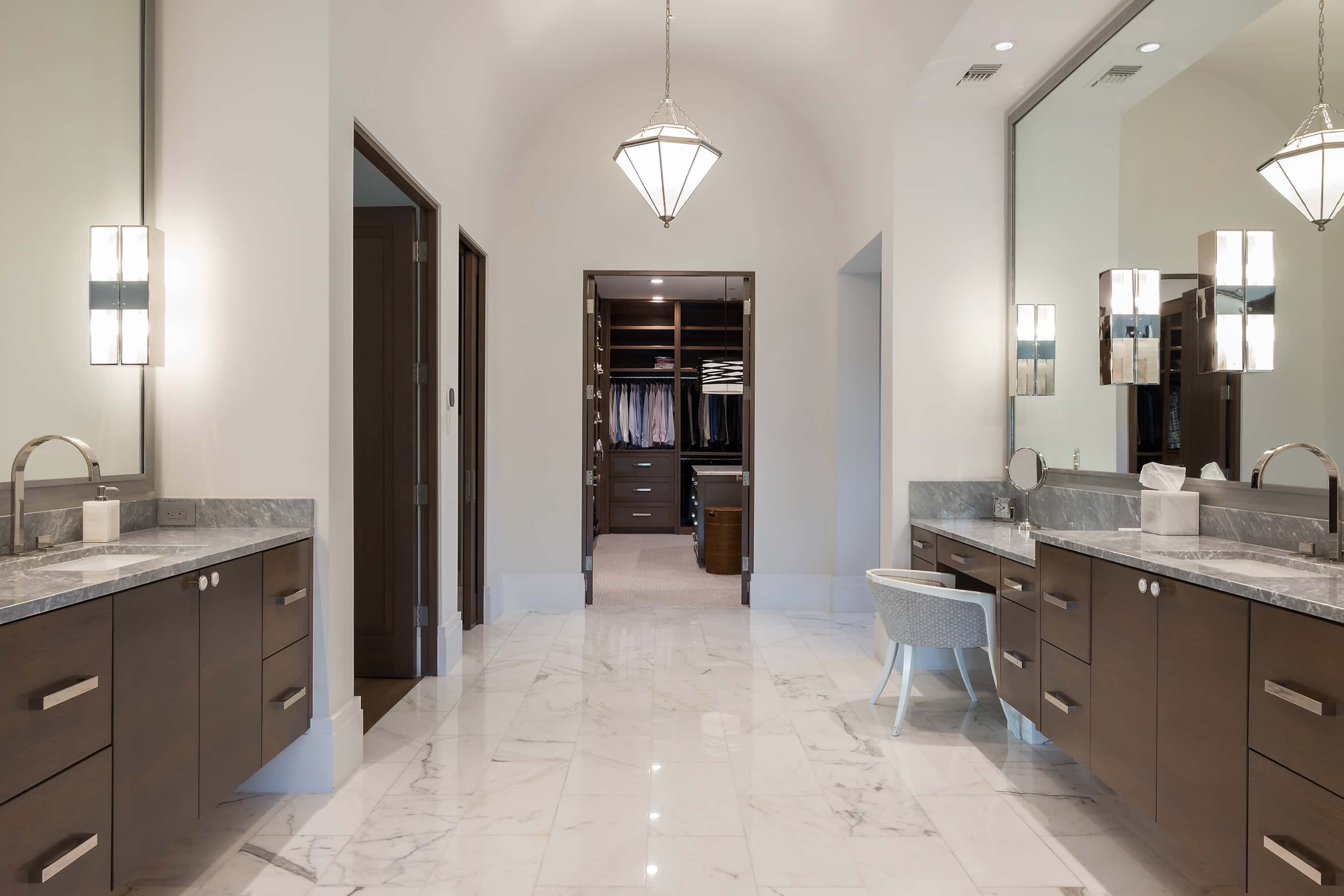 The bathroom off of the primary suite offers two walk-in closets.