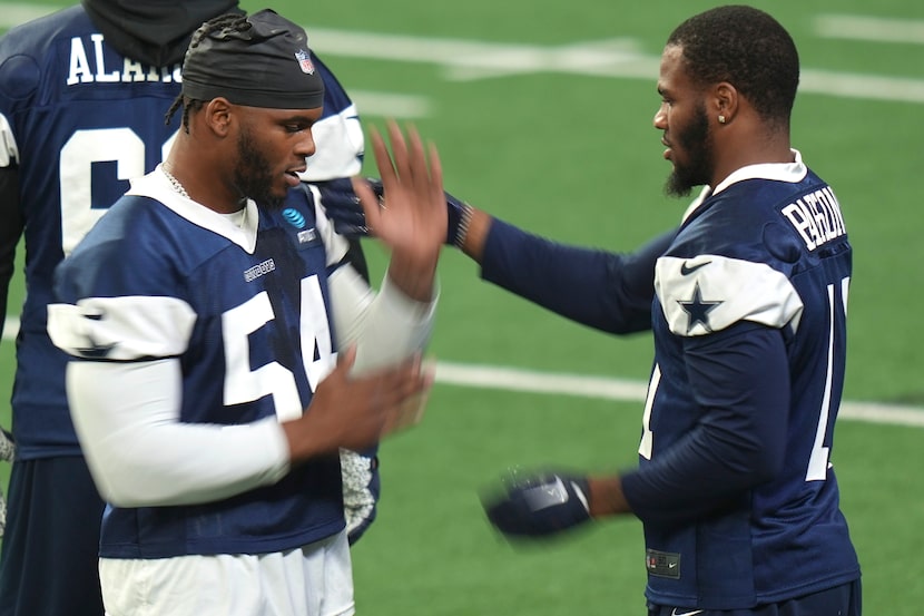 Dallas Cowboys defensive end Sam Williams (54) and linebacker Micah Parsons (11) work on...