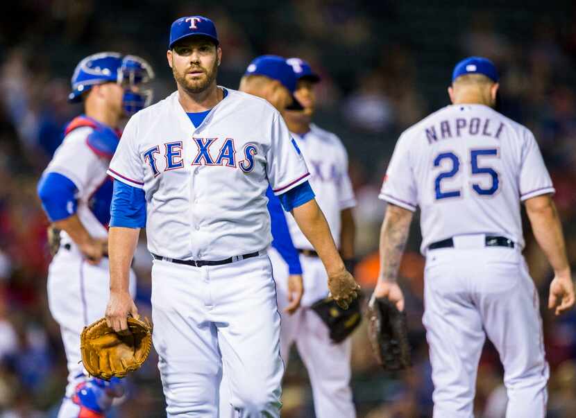 Texas Rangers starting pitcher Colby Lewis (48) leaves the game during the sixth inning...