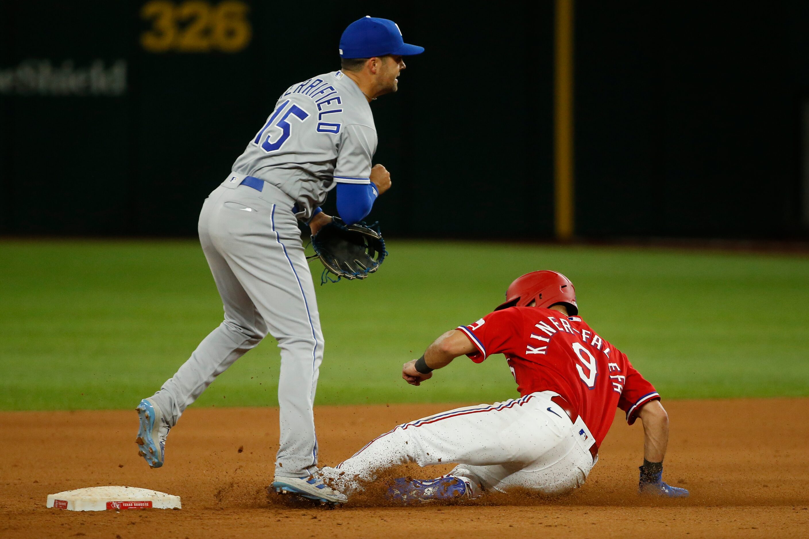 Kansas City Royals second baseman Whit Merrifield (15) starts a double play ahead of a...