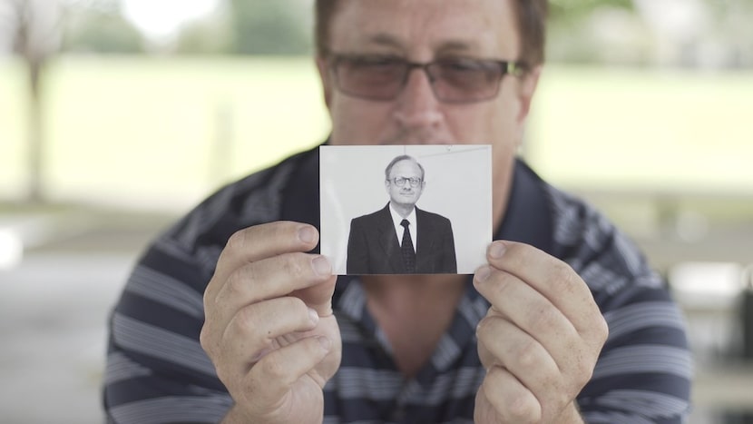 Guy Moore, son of the Rev. Charles Moore, holds a photo of his father in the PBS Independent...