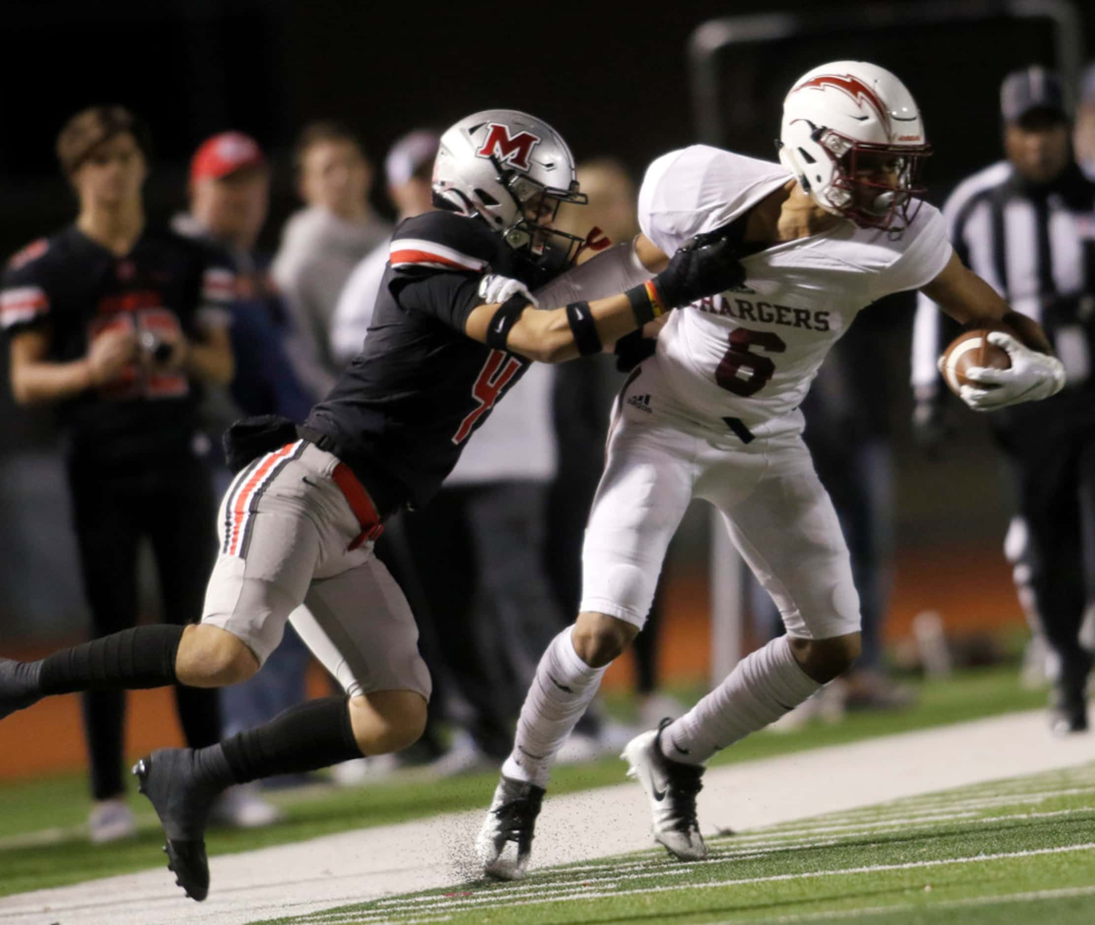 Keller Central receiver Justin Garrett (6) is tackled by Flower Mound Marcus defensive back...