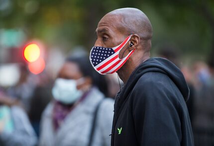 First time voter John T. Hillman waits in line at the American Airlines Center in Dallas...