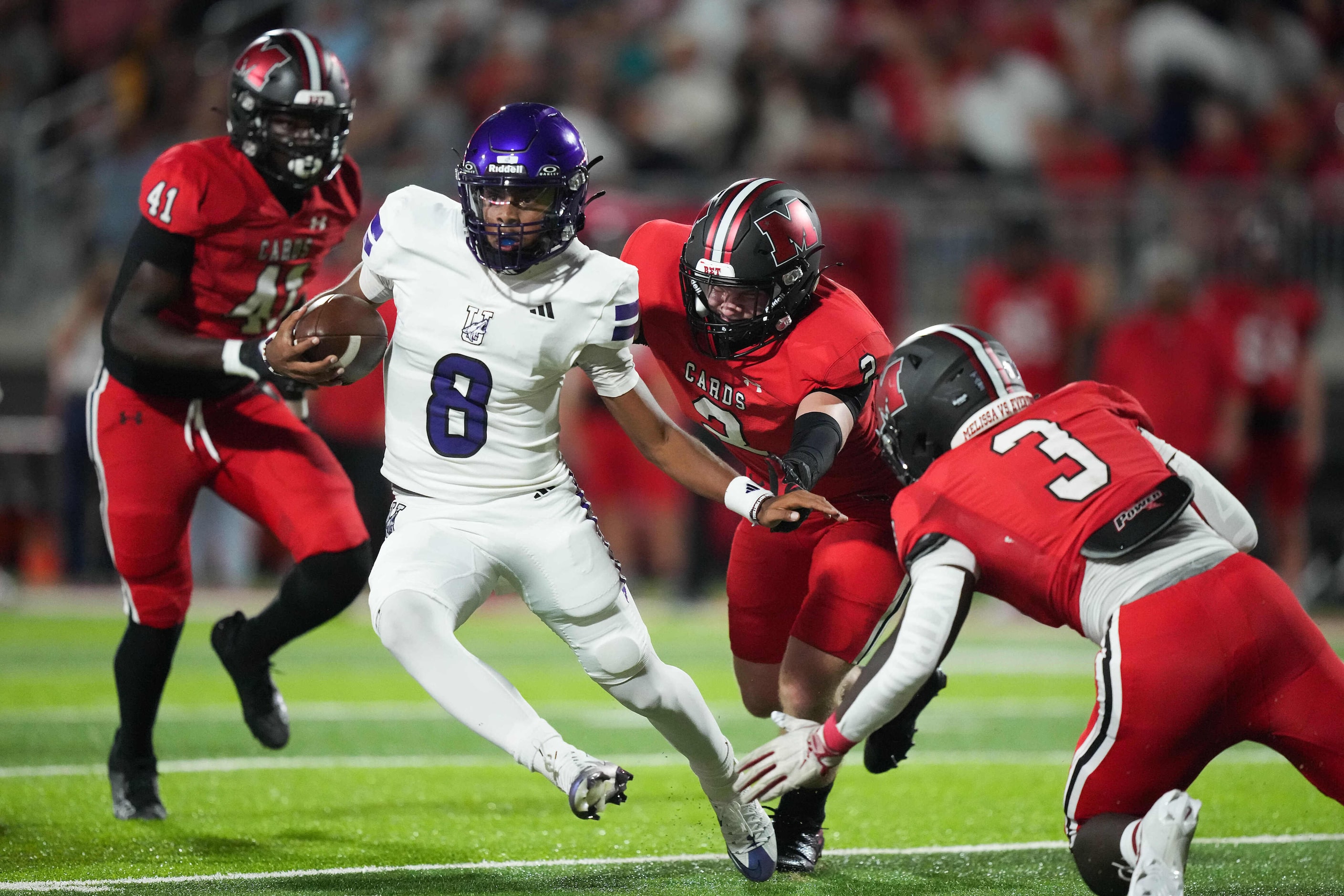 Anna quarterback Ziondre Williams (8) cuts between Melissa linebackers Greyson Dunnahoe (2)...