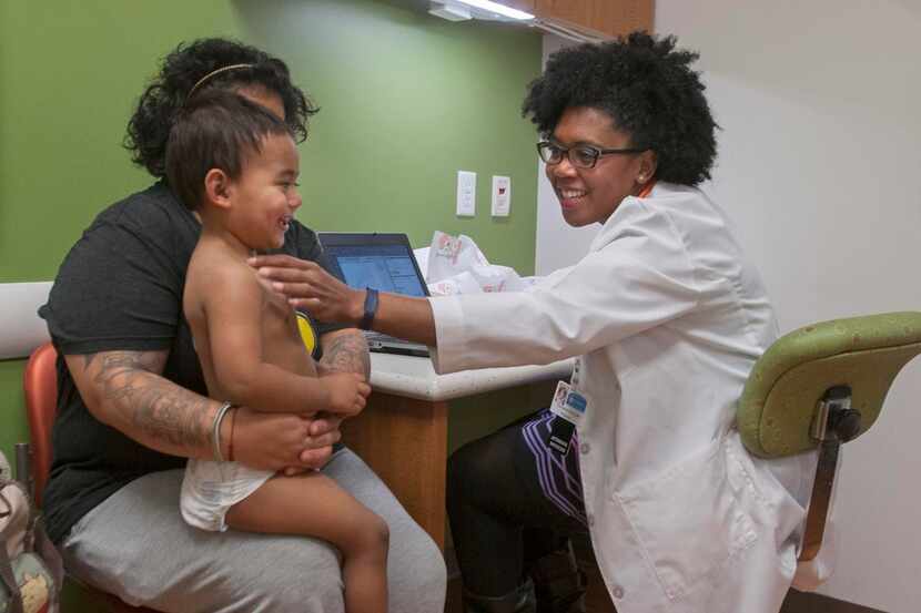 
Dr. Tonya McDonald, a pediatrician at My Children’s Clinic in South Dallas, tickles...