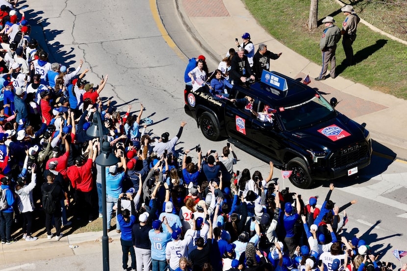 Texas Rangers owner Ray Davis and president Neil Leibman wave to the crowd during the...