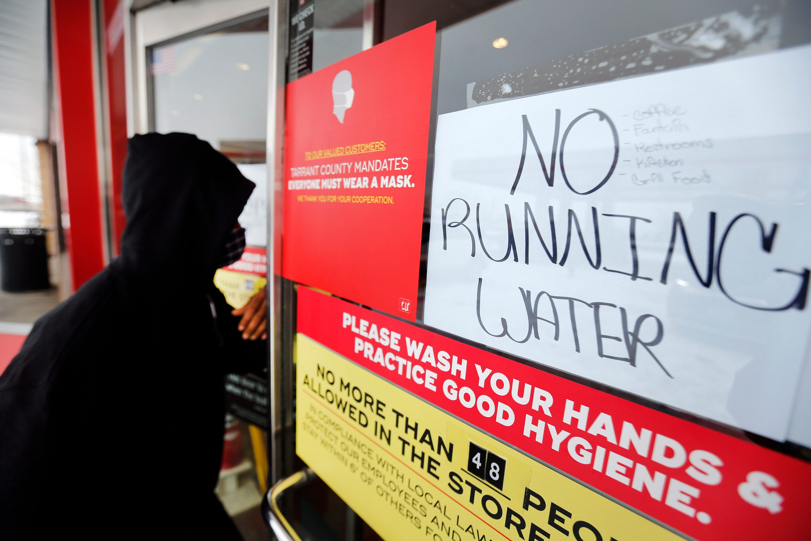 A sign advises customers entering a South Arlington QT that they have no running water,...