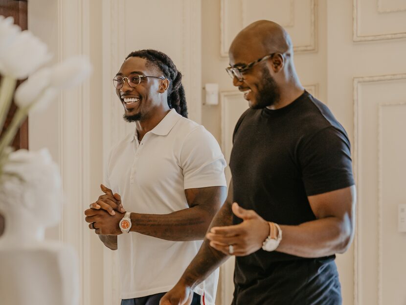 DeMarcus Lawrence (left) and DeMarcus Ware enjoy a laugh while shooting an episode for...