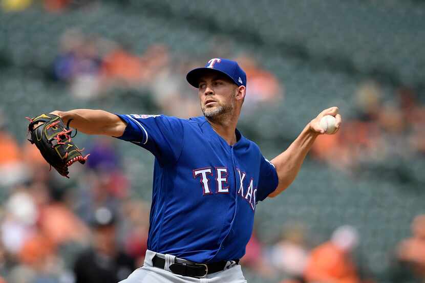 Texas Rangers starting pitcher Mike Minor delivers a pitch during the first inning of a...