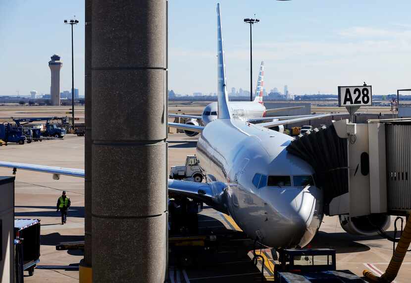 An American Airlines plane is parked at a Terminal A gate at Dallas-Fort Worth International...