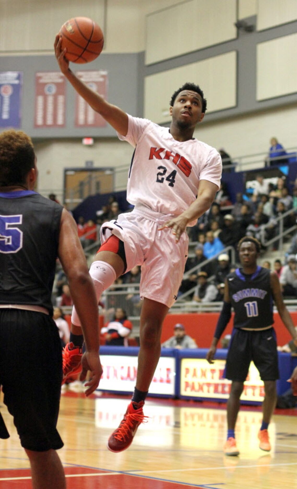 Dallas Kimball guard Cordel Finley (24) releases a hook shot as moves inside the Mansfield...