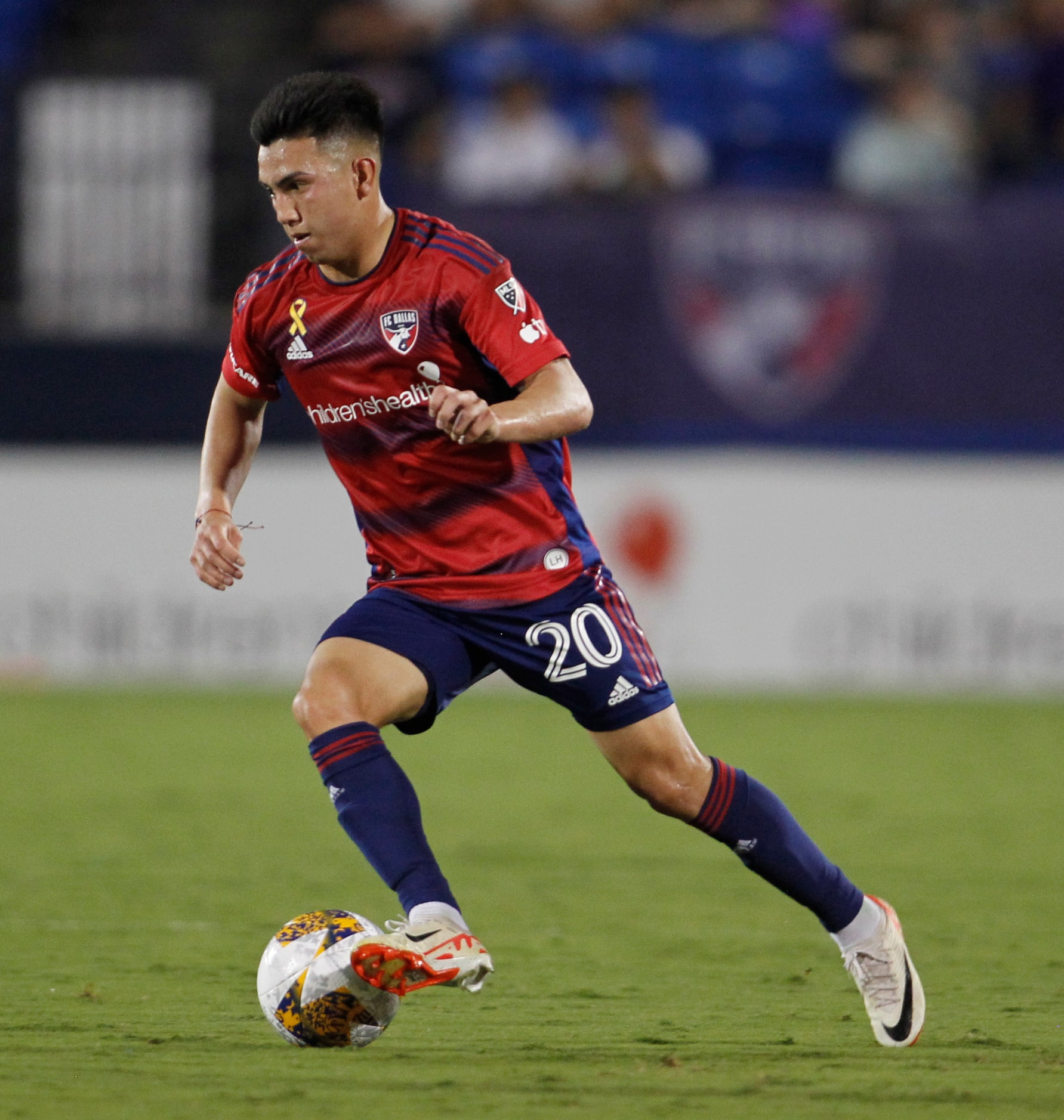 FC Dallas midfielder Alan Velasco (20) moves the ball past midfield during first half action...