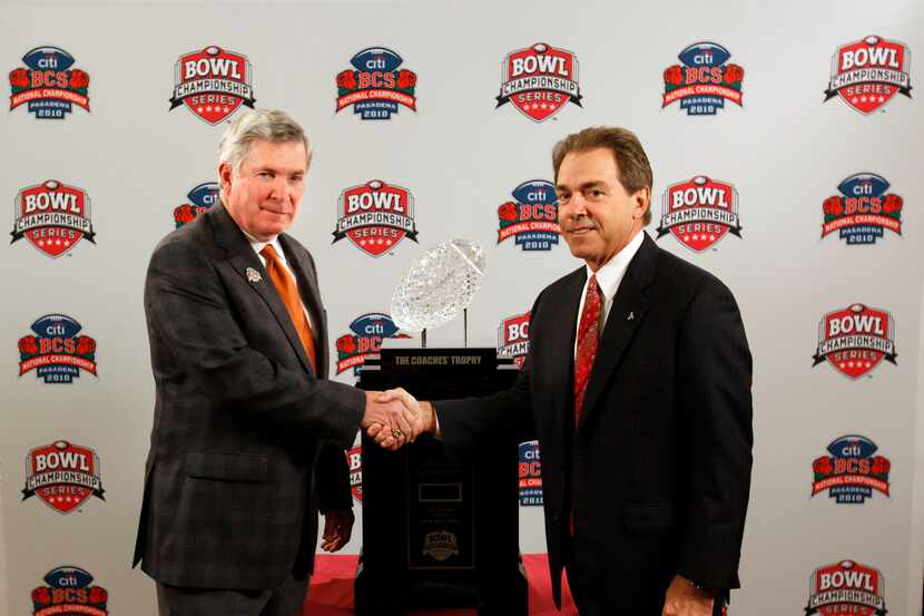 University of Texas' head coach Mack Brown and University of Alabama's Nick Saban shake...