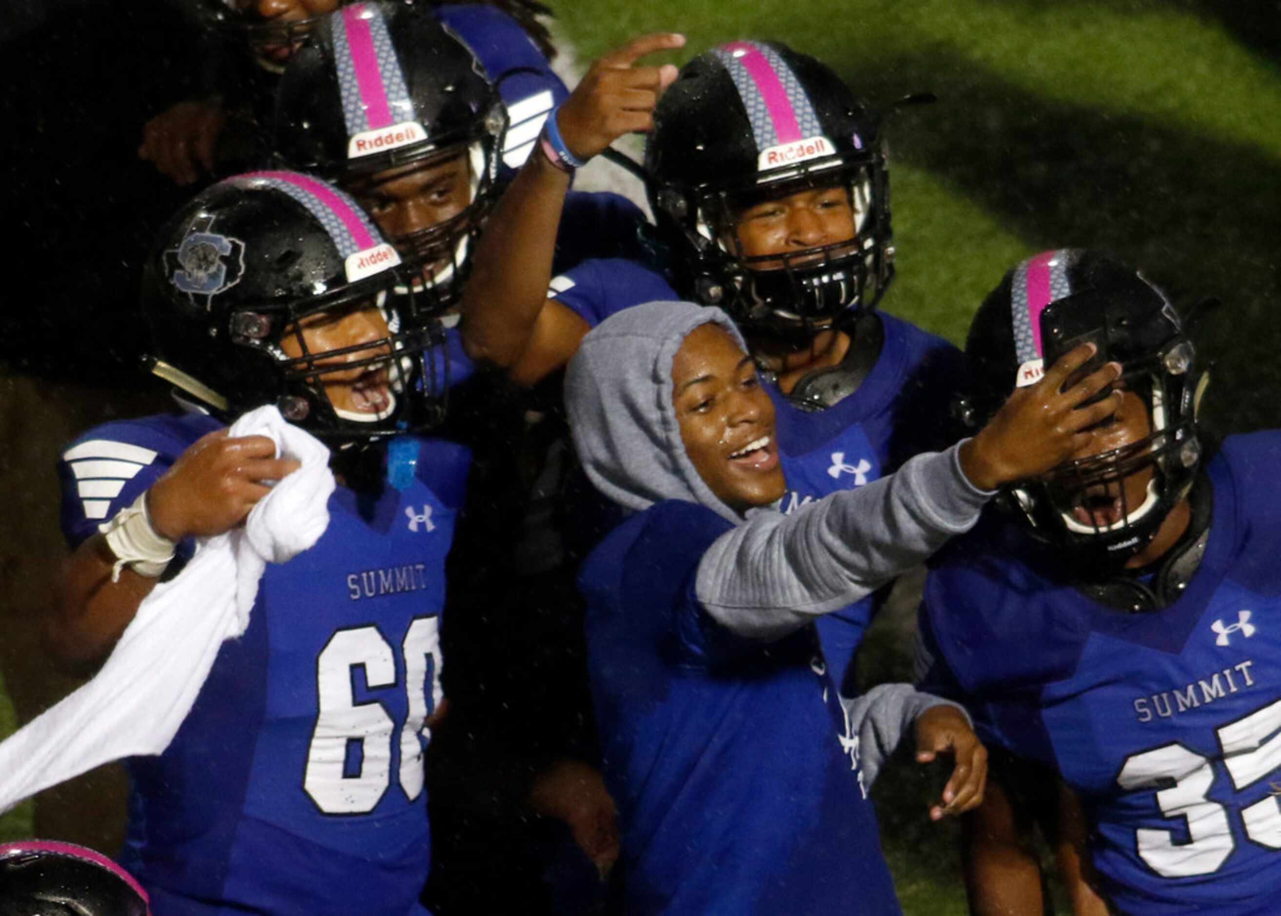 A group of Mansfield Summit players celebrate the moment on the field following their 27-26...