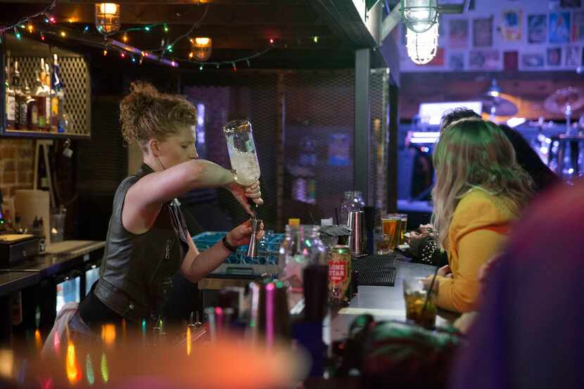 Bartender Caitlin Griffith of Denton pours a drink at Venue located at Andy's Bar and Grill...