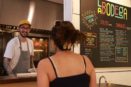 Chef Bryan Driver chats with cashier Ava Martel at La Bodega in Dallas. Foodies are buzzing...