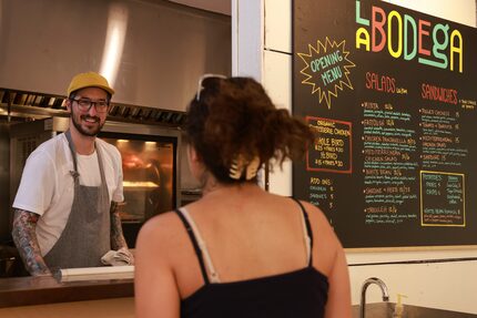 Chef Bryan Driver chats with cashier Ava Martel at La Bodega in Dallas. Foodies are buzzing...