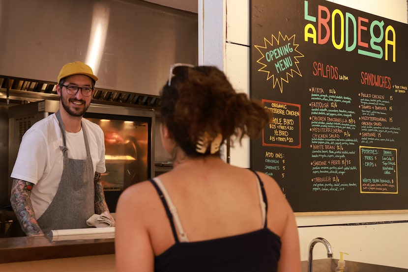 Chef Bryan Driver chats with cashier Ava Martel at La Bodega in Dallas.