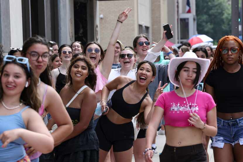 Harry Styles’ fans jumped out of line on Main Street to get their photo taken while waiting...