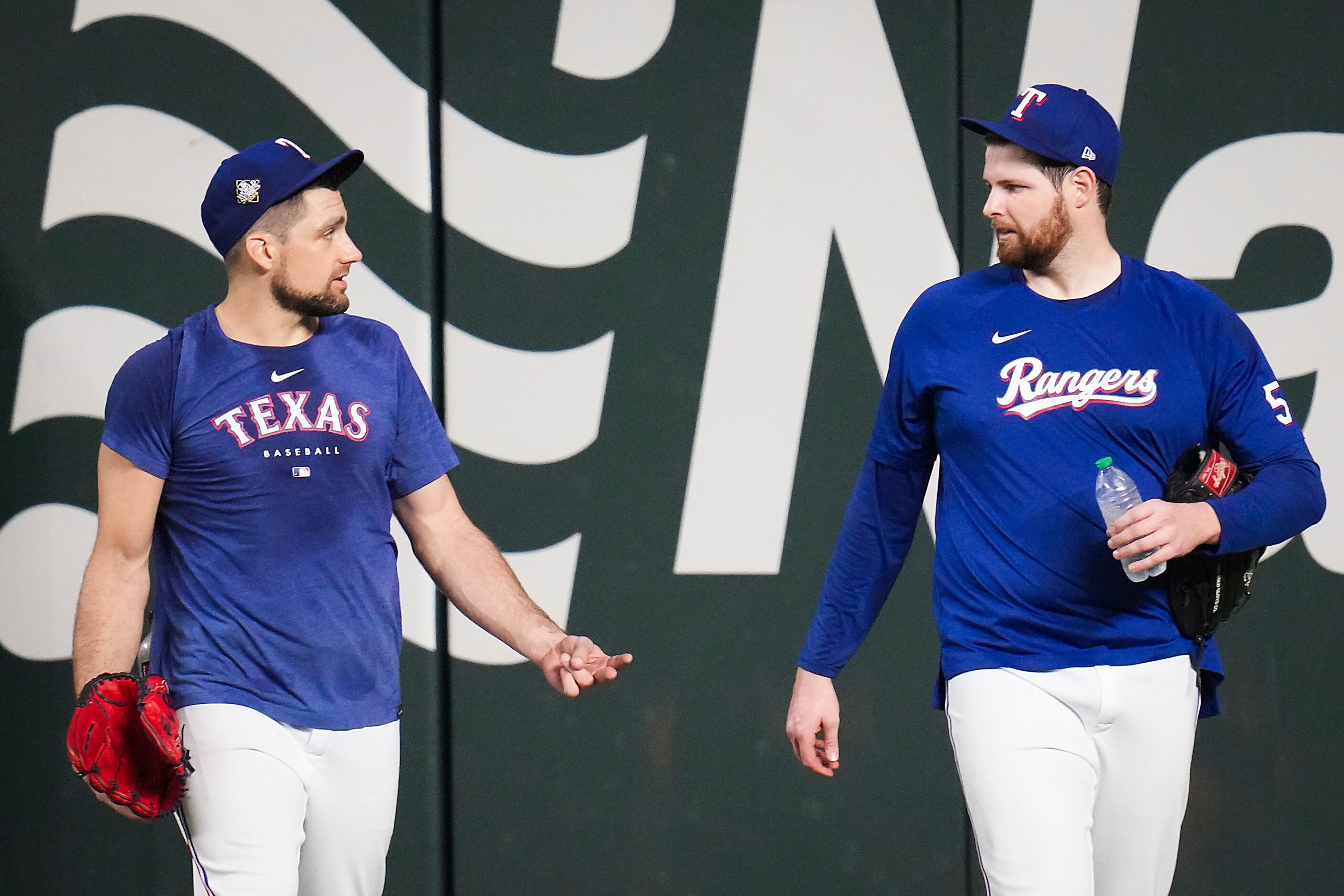 Texas Rangers starting pitchers Nathan Eovaldi (left) and Jordan Montgomery walk from the...