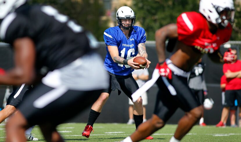 Texas Tech quarterback Nic Shimonek takes the snap from center as he runs a team play during...