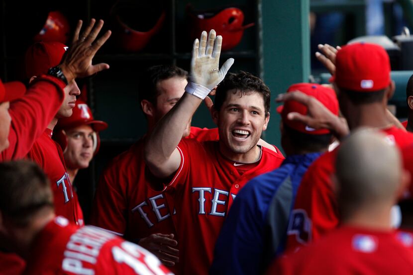 Texas Rangers second baseman Ian Kinsler (5) celebrates with teammates after hitting a home...