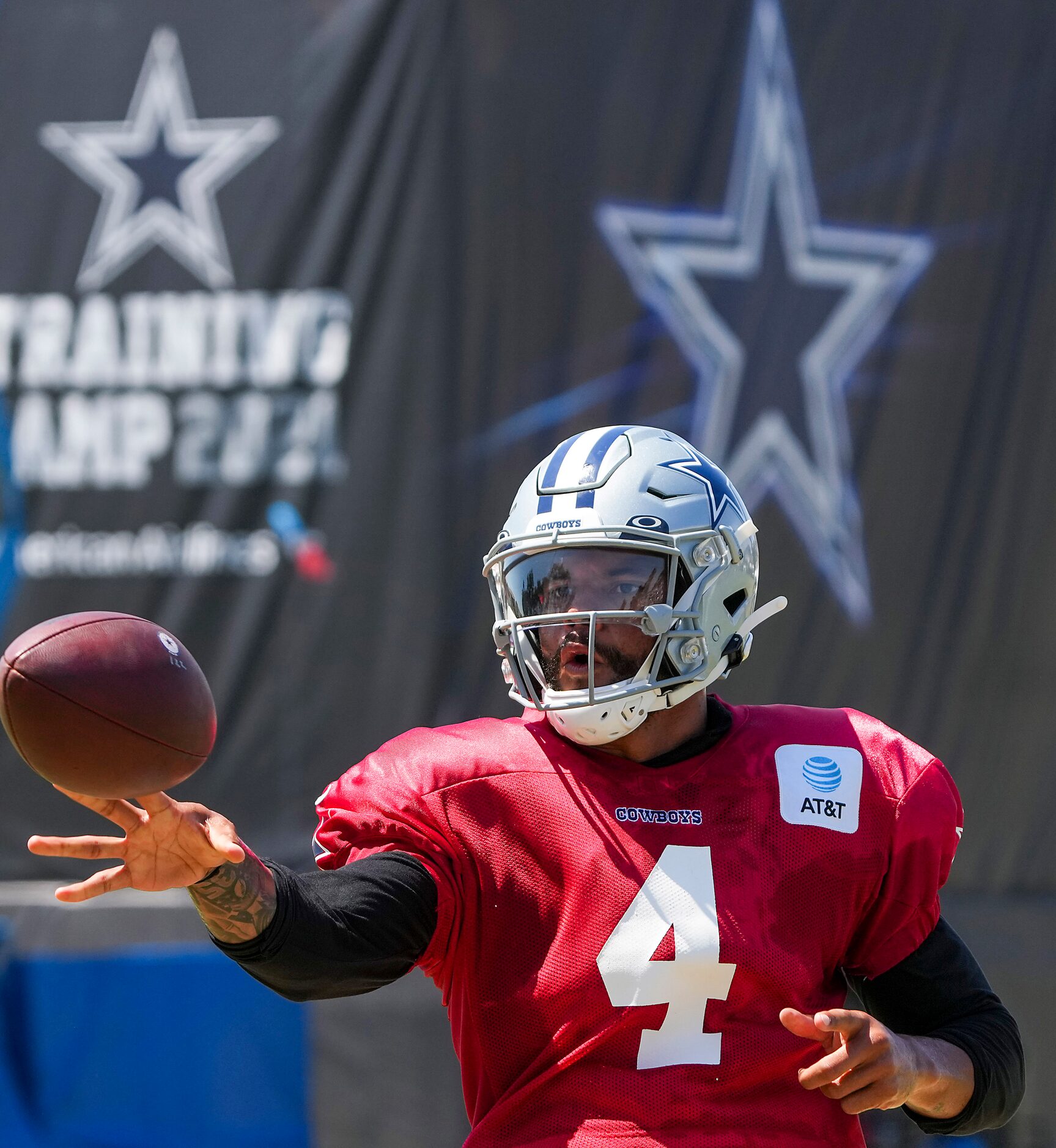 Dallas Cowboys quarterback Dak Prescott makes a shovel pass into a net during a practice at...