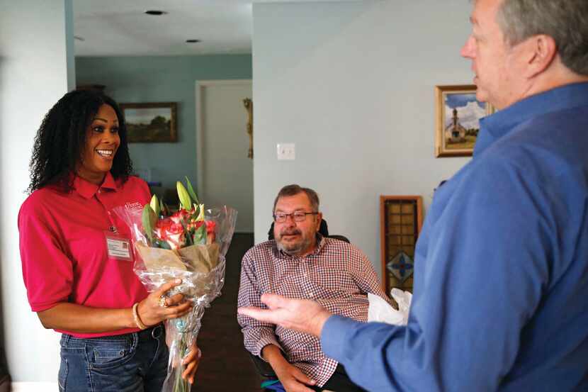 Todd Felker (right), of Home Instead Senior Care presented caregiver Fatou Coker Singhateh...