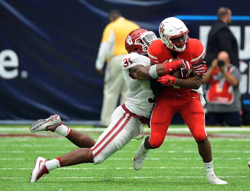 FILE - In this Sept. 3, 2016, file photo, Houston quarterback Greg Ward Jr. (1) is tackled...