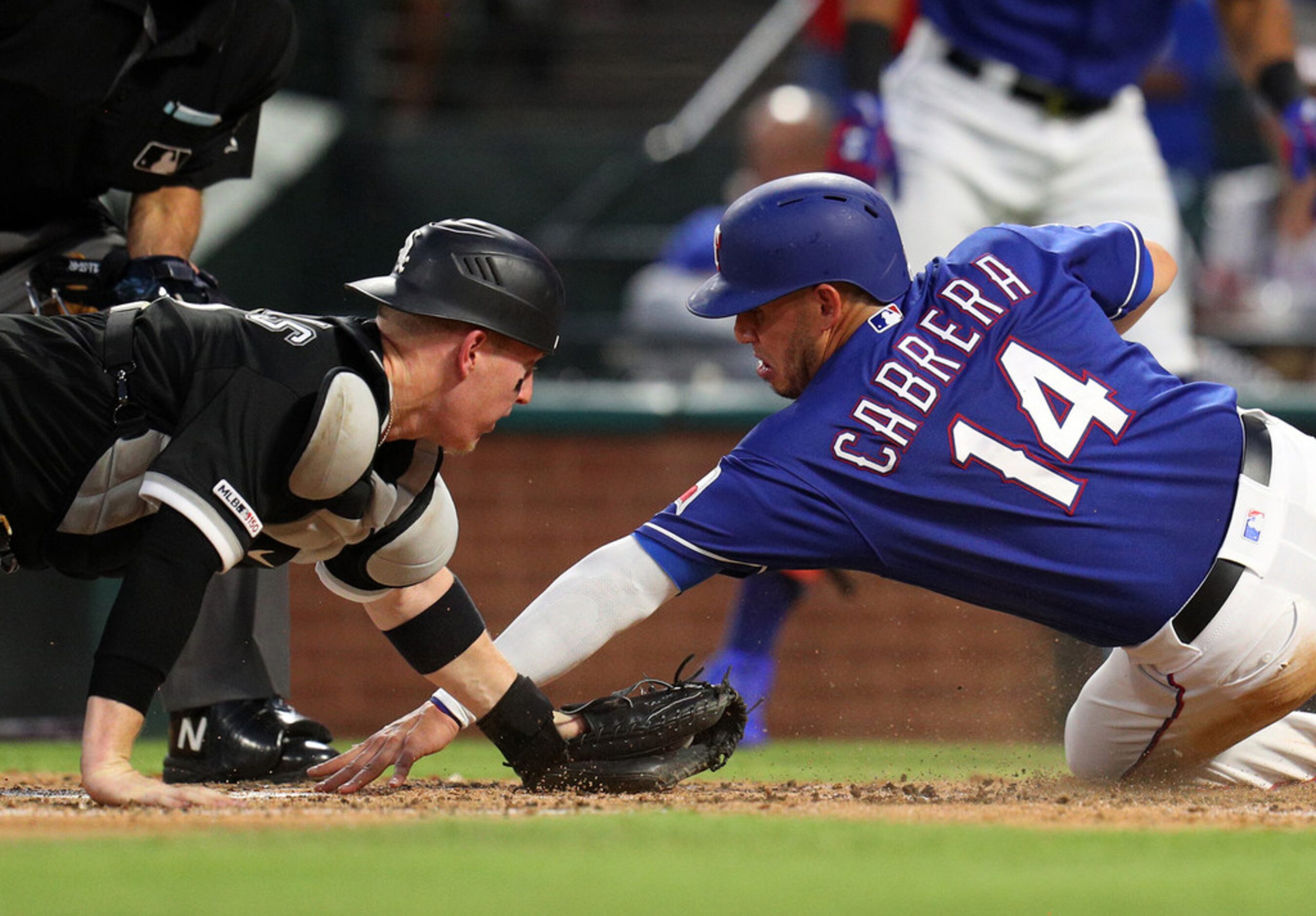 Chicago White Sox catcher Zack Collins, left, makes the tag on the Texas Rangers' Asdrubal...