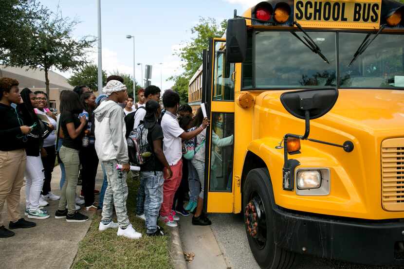 Students board a bus after school in September in Houston. Black students continue to be...