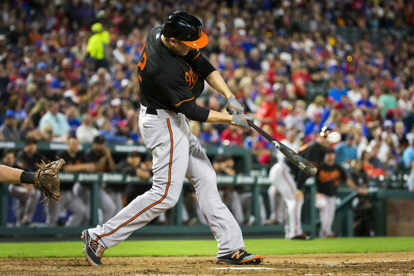 Baltimore designated hitter Mark Trumbo hits a home run, his second of the inning, during...