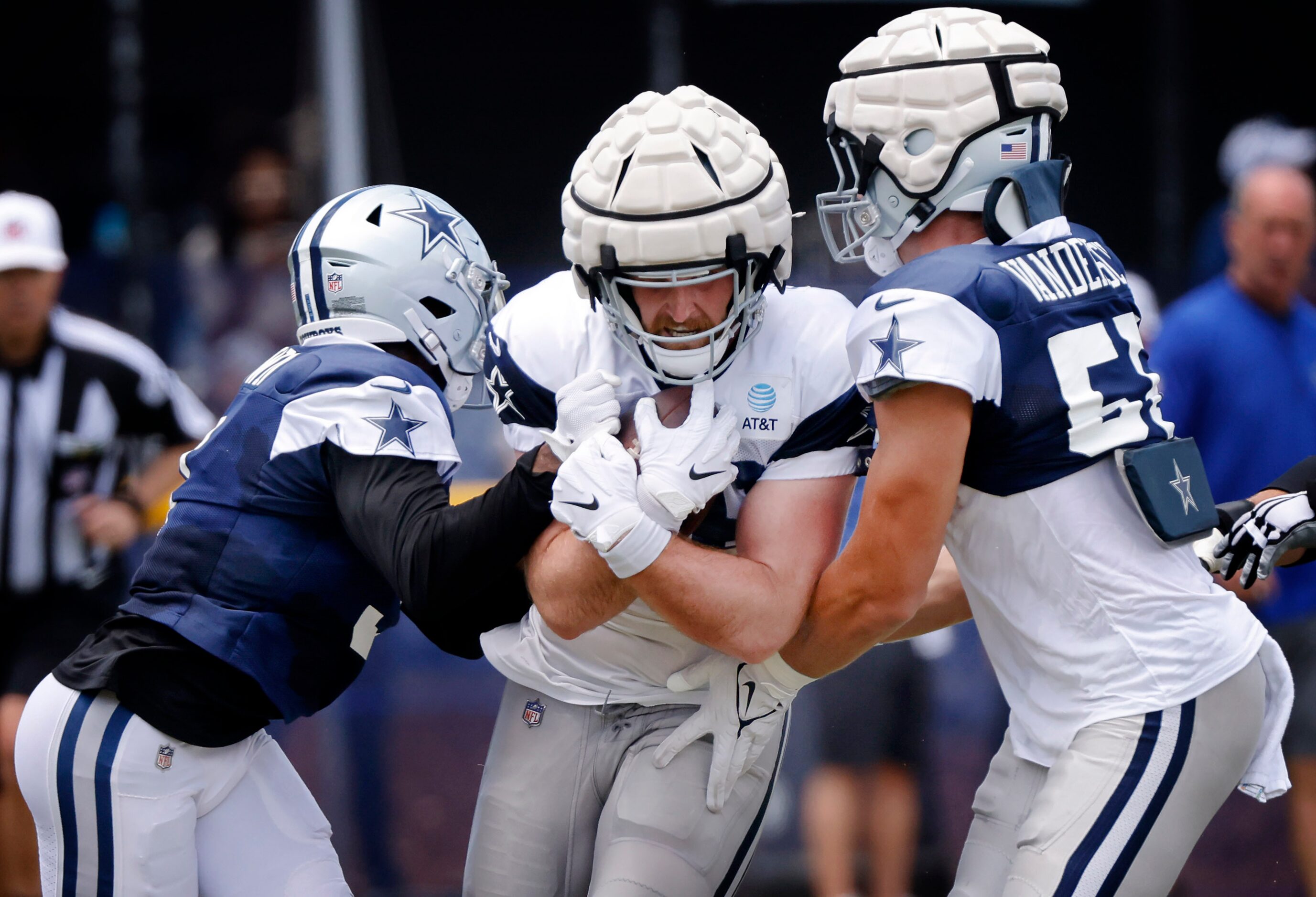 Dallas Cowboys tight end Dalton Schultz (86) is hit by outside linebacker Leighton Vander...