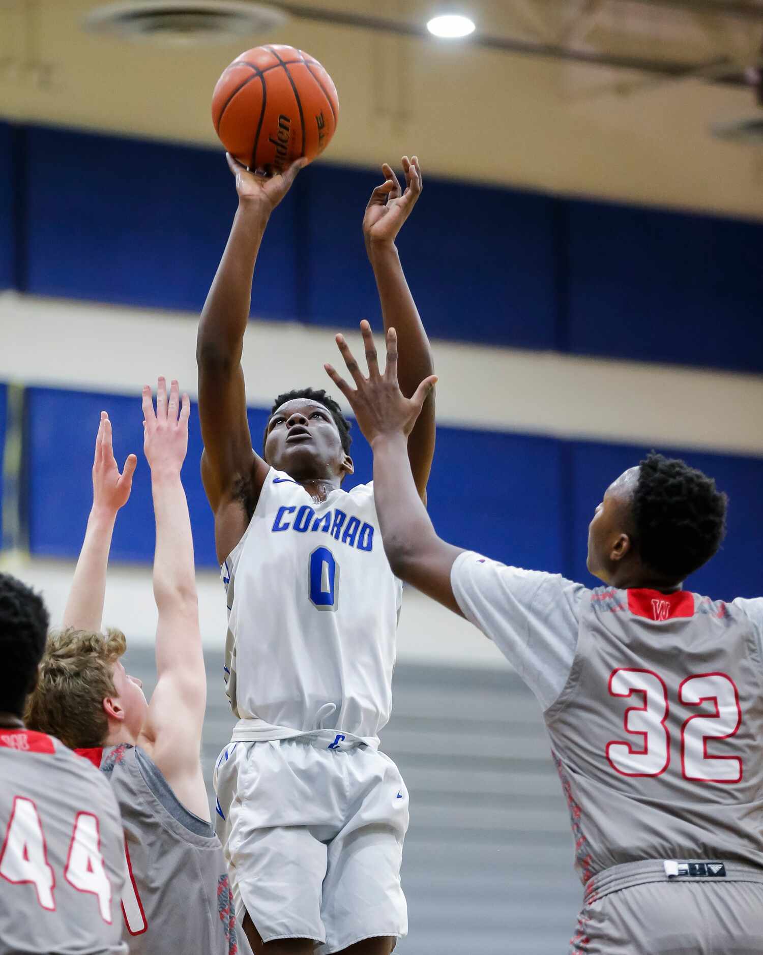 Conrad senior forward Joe Joe Yelegayhee (0) attempts a shot as Woodrow Wilson junior guard...