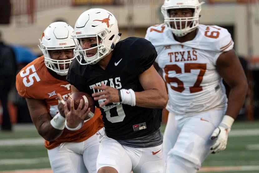University of Texas quarterback Casey Thompson (8) scrambles out of the pocket for a first...