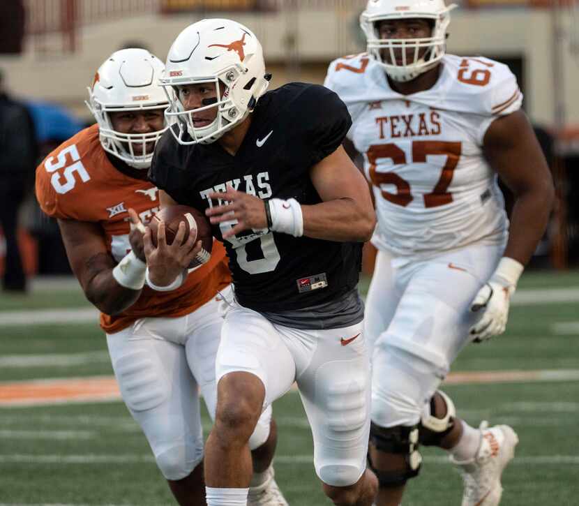 University of Texas quarterback Casey Thompson (8) scrambles out of the pocket for a first...