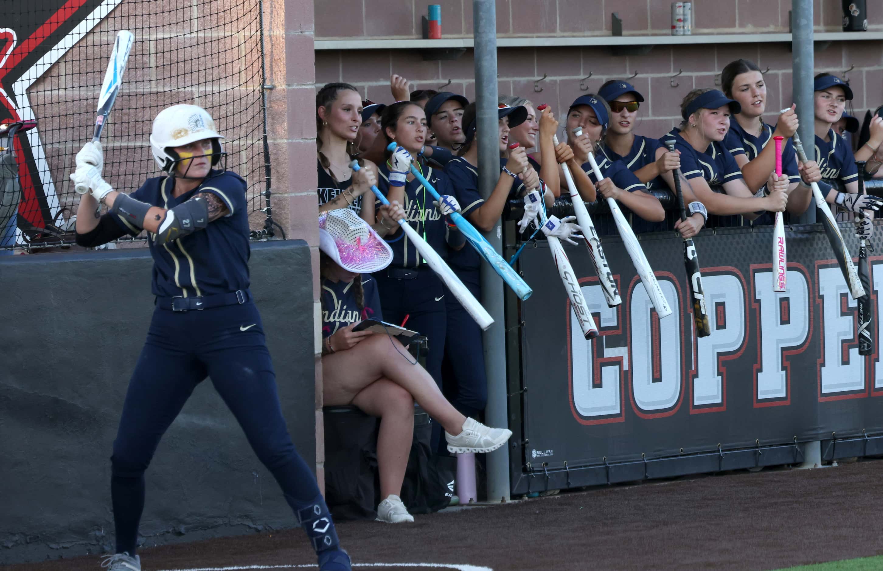 Keller players show their support from the team dugout during the 3rd inning of play against...