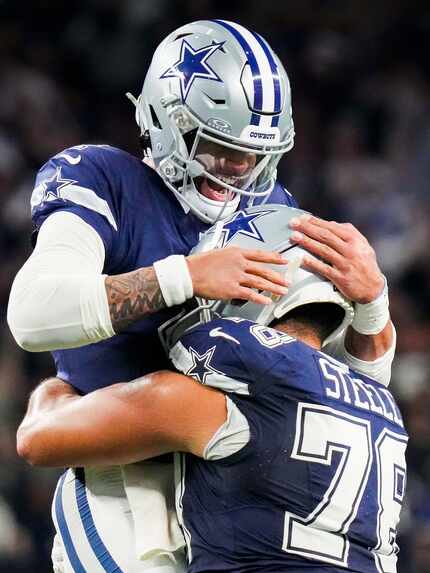 Dallas Cowboys quarterback Dak Prescott (4) celebrates with offensive tackle Terence Steele...