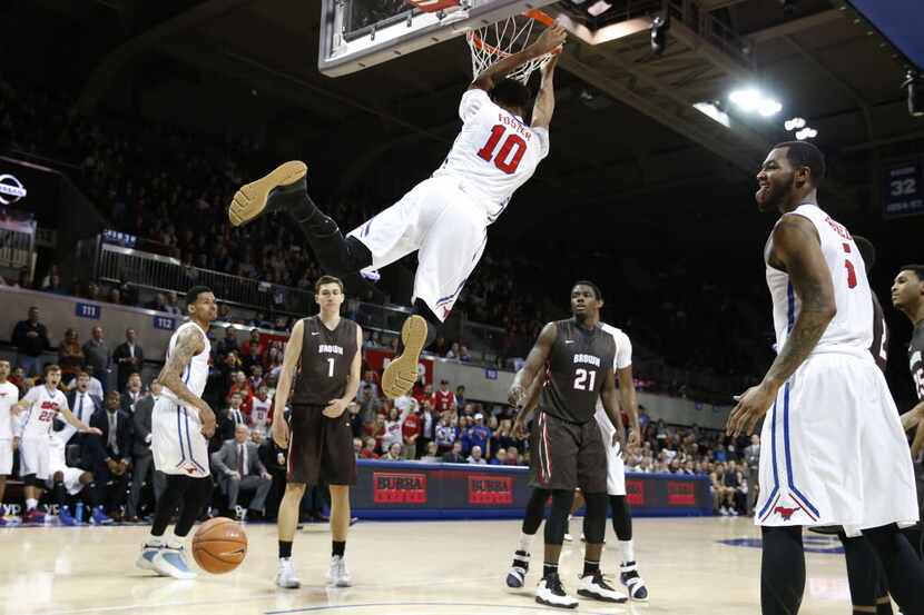 SMU guard Jarrey Foster (10) hangs on the rim after a dunk during the second half of play at...