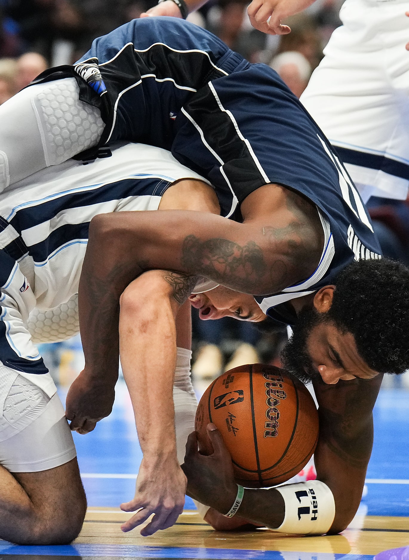 Dallas Mavericks guard Kyrie Irving (11) wrestles for a loose ball with Memphis Grizzlies...